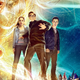 R.L. Stine and two teens stand in fear, surrounded by garden gnomes, while an evil ventriloquist dummy's head appears in the sky.